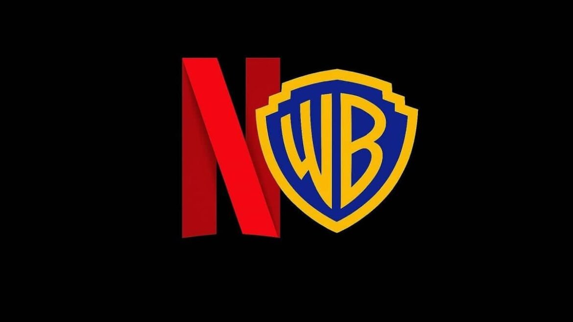 Logotipo de Netflix junto al de Warner Bros. Discovery en una mesa de negociaciones